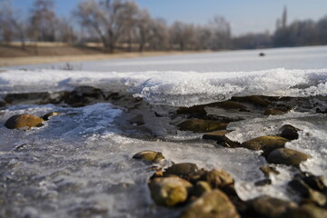 A layer of ice covered the small town lake.