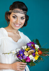Beautiful bride with colorful wedding bouquet in her hands