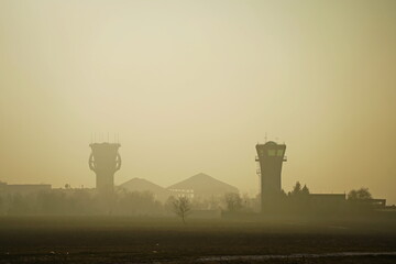 Fototapeta premium The runway area at sunset with fog and smog.