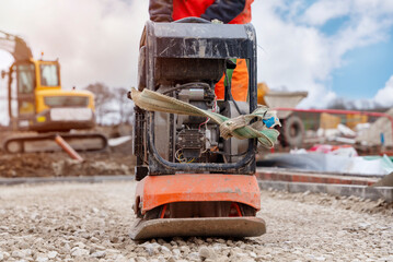 Vibrating plate compactor osed to compact ground and stone on building site