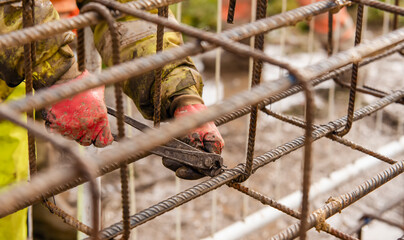 Construction worker steel fixer working at the building  site close-up