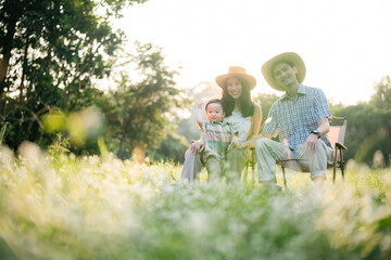 happy harmonious family outdoors concept father and mother and son have activities together on holidays, nature grassland field - obrazy, fototapety, plakaty