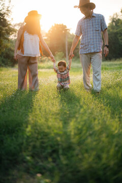 Happy Harmonious Family Outdoors Concept Father And Mother And Son Have Activities Together On Holidays, Nature Grassland Field