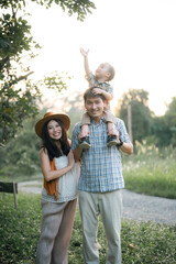 happy harmonious family outdoors concept father and mother and son have activities together on...