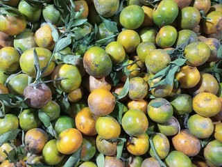 lots of yellow green oranges in traditional markets