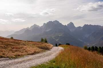 Scenic hiking trail along alpine meadows of mount Helm (Monte Elmo) in Carnic Alps at Austria Italy border, Europe. Panoramic view of majestic mountain range of untamed Sexten Dolomites in South Tyrol