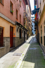 The narrow street of the old European city, Portugalete, Basque Country, Spain.