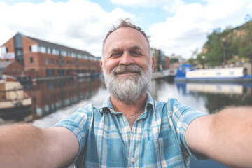 retirement walking on the quays, pier, sitting on bench, taking selfie, having video chat, looking...