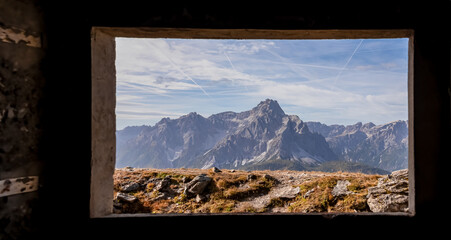 View from window of remains of military bunker First World War, mount Helm (Monte Elmo). Looking at summit Dreischusterspitze in mountain range of untamed Sexten Dolomites, South Tyrol, Italy, Europe - obrazy, fototapety, plakaty