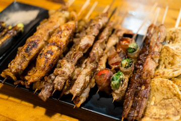 Variety of meat skewers on dish