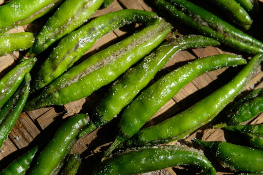 Sun-drying green chillies stuffed with salt.
