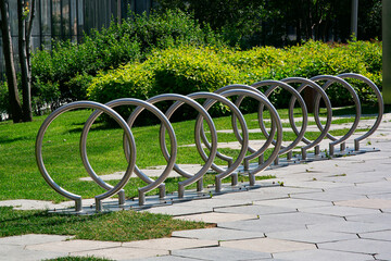 parking for a bicycle in a city park in sunny summer weather.