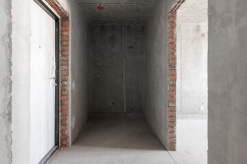 Fototapeta premium interior of the apartment without decoration in gray colors. rough finish