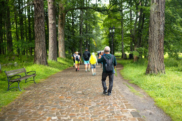 People with backpack in mountains. Tourists walking on a stone path in mountain. Hikers on a trip...