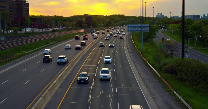 Aerial view of highway vehicles streaming along creating vibrant rhythm of traffic. Traffic pulse of city highway bustling with traffic Endless stream of traffic symbol of active urban roads.