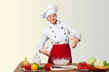 Young beautiful woman chef cooking  in kitchen