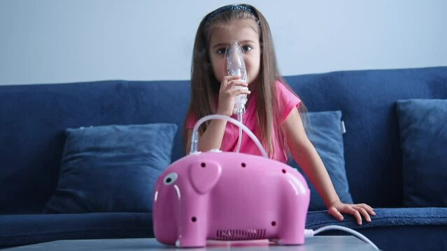 Portrait of little child in an inhalation mask. Children's lung health concept. Slow Motion Effect.