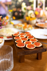 Wedding table for guests, decorated with candles, are served with cutlery and crockery and covered with yellow tablecloth