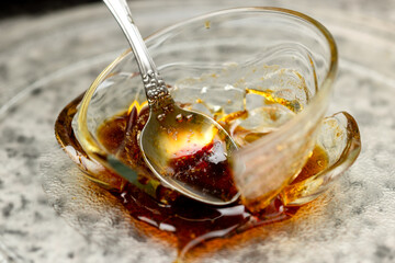 A metal spoon in a cup of honey when heated in a microwave oven led to destruction. Close-up
