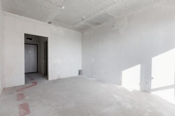 interior of the apartment without decoration in gray colors. rough finish