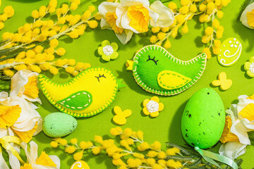 Easter composition with traditional spring flowers and handmade felt birds. Decorative eggs,rabbits