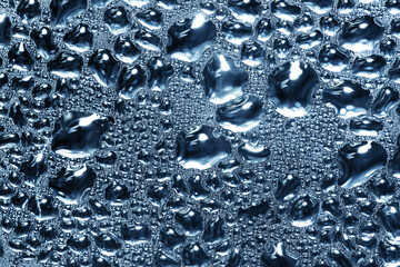 Water drops background. Wet glass surface texture. Winter window condensation problem. Bubble dew...