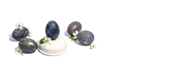 Easter egg on a beton stand isolated on white background. Traditional symbol, blooming cherry