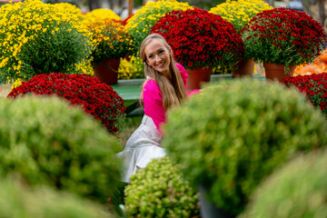 A Lovely Blonde European Model Enjoys Shopping For Flowers For The Halloween Holiday