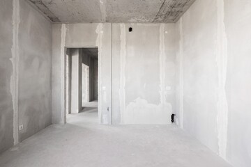 Fototapeta premium interior of the apartment without decoration in gray colors. rough finish
