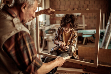 Grandfather Teaching Woodworking to His Grandson