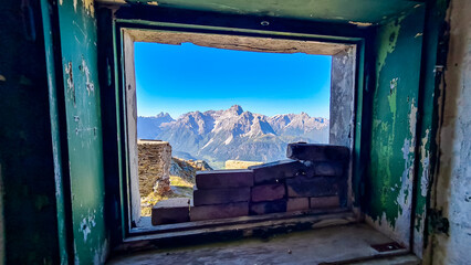 View from window of remains of military bunker First World War, mount Hornischegg. Looking at peak Dreischusterspitze in mountain range of untamed Sexten Dolomites, South Tyrol, Austria Italy, Europe