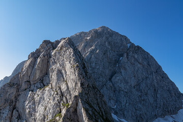 Obraz premium Scenic view from Mangart Saddle (Mangartsko sedlo) on majestic mountain peak Mangart in untamed Julian Alps, Friuli Venezia Giulia, Italy, Europe. Hiking wanderlust in alpine wilderness Italian Alps