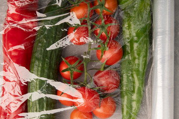 Storing food and vegetables in cling film.