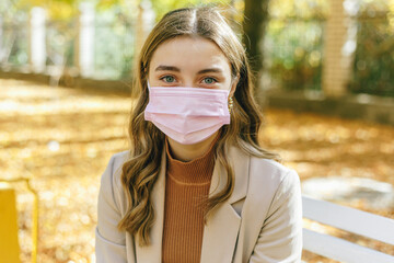 Sick woman in autumn park