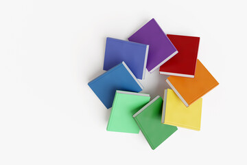Set of books having rainbow colors arranged in a circular manner on white background. Illustration of the concept of reading, studying and education