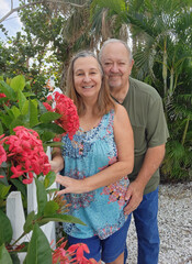 senior adult couple beside fence and flowers
