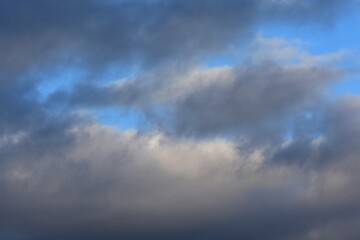 Obraz premium Cloudscape, Colored Clouds at Sunset near the Ocean on a Blue Sky