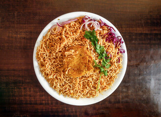 Plain pulao with shami kabab onion and cabbage served in plate isolated wooden background top view...