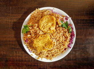 Spicy Plain pulao with shami kabab onion and cabbage served in plate isolated wooden background top view indian spices and pakistani food