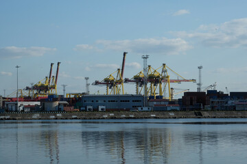 view of the industrial area and construction cranes