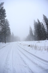 Fototapeta premium Snowy road in Sudety mountains, Poland