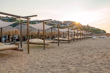 Sunrise, morning on the beach in the town of Saint Vlas, Bulgaria. An empty beach bathed in sunlight.