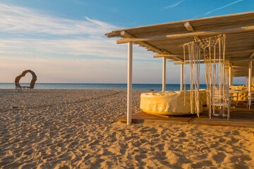 Sunrise, morning on the beach in the town of Saint Vlas, Bulgaria. An empty beach bathed in...