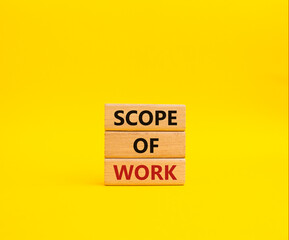 Scope of Work symbol. Concept words Scope of Work on wooden blocks. Beautiful yellow background. Business and Scope of Work concept. Copy space.
