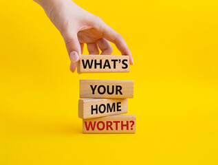 What is your home worth symbol. Wooden blocks with words What is your home worth. Businessman hand....