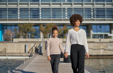 two sisters who spend time together having fun strolling along a pier