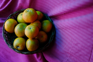 Close up shot of Kinnow Oranges in wooden basket