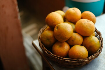Close up shot of Kinnow Oranges in wooden basket © ravinepz