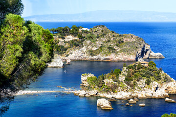 View from above under an intensely blue sky of the stunning seascape with Isola Bella at the foot...