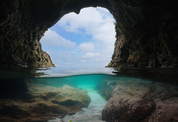 View from a sea cave on the Atlantic coast of Spain, split level view over and under water surface,...